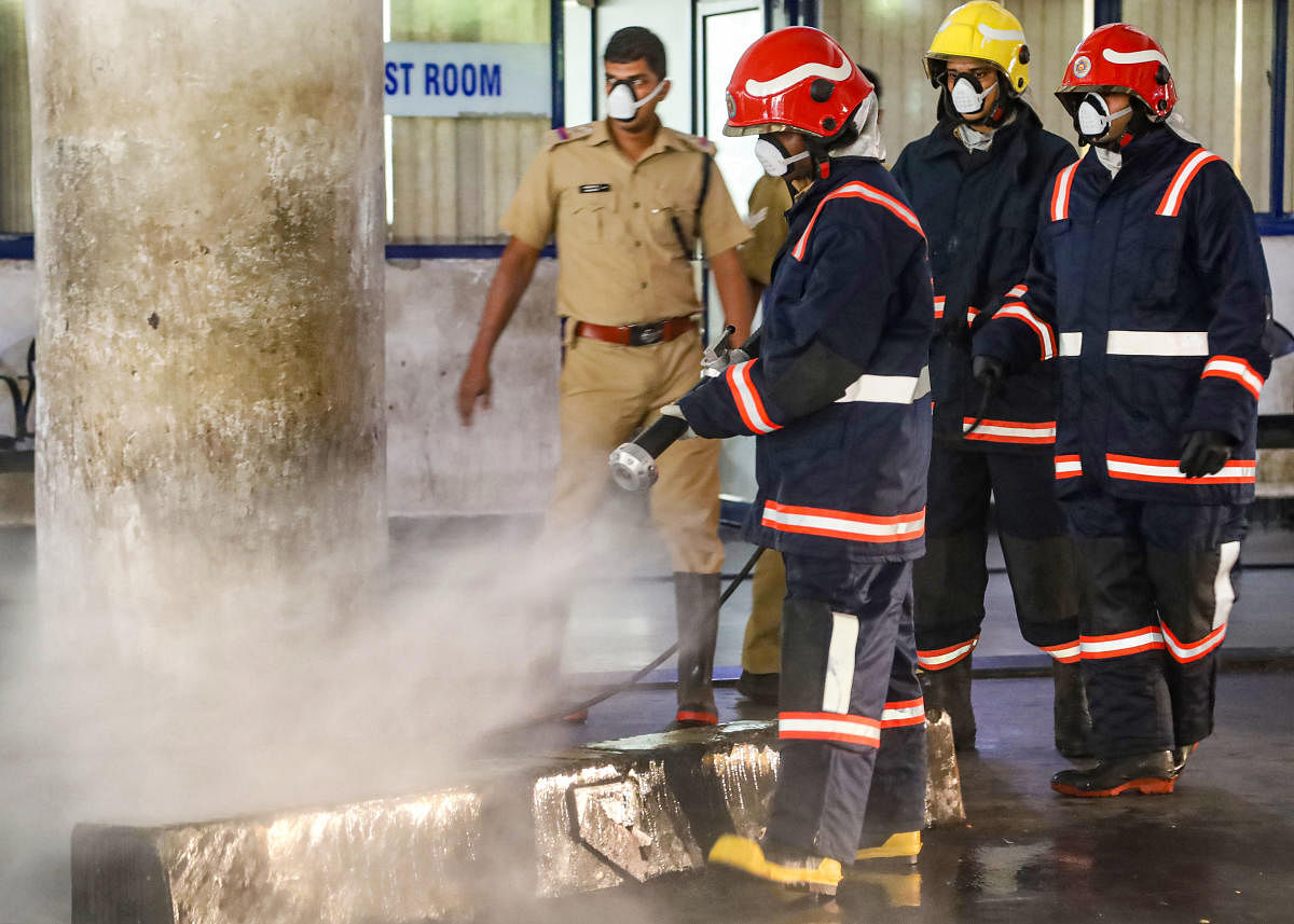 Workers spray disinfectant (PTI Photo)