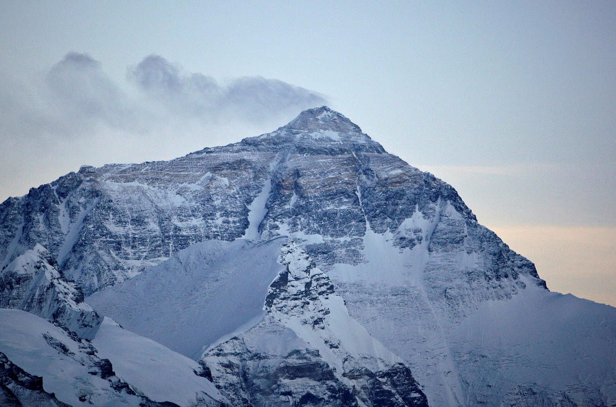 Wind blows snow off the summit at dusk of the world's highest mountain Mount Everest, also known as Qomolangma, in the Tibet Autonomous Region. Credit: Reuters File Photo