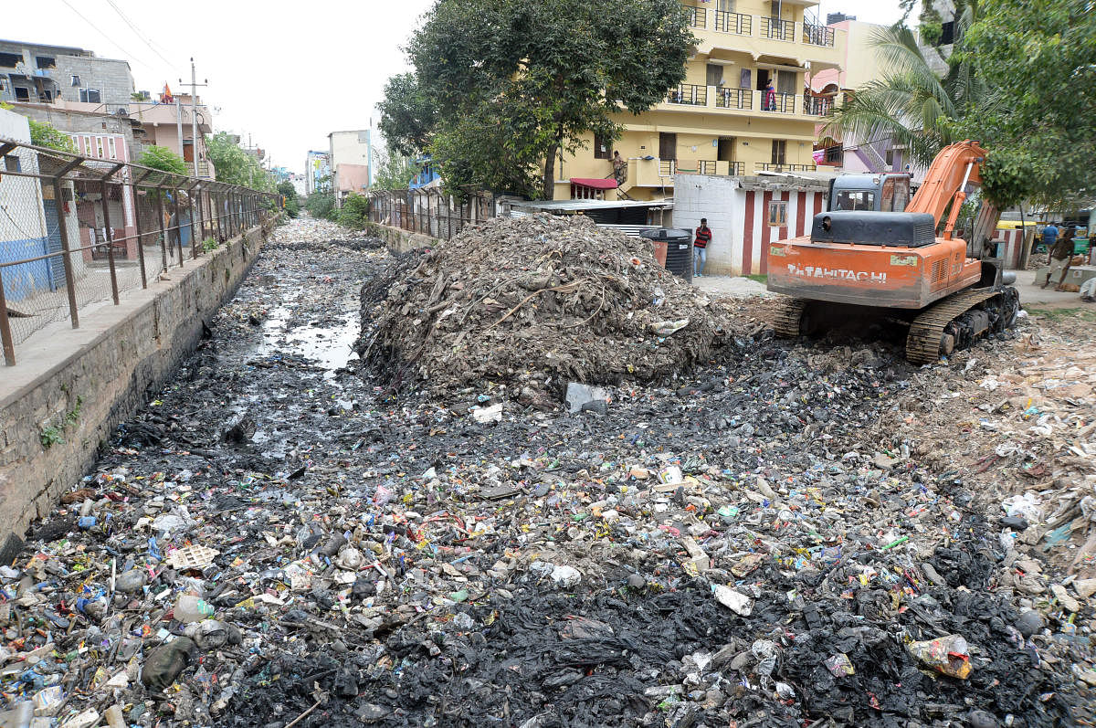 A view of Rajakaluve which is filled up plastic and other waste meterial next to KPWD Quarters, Koramangala.