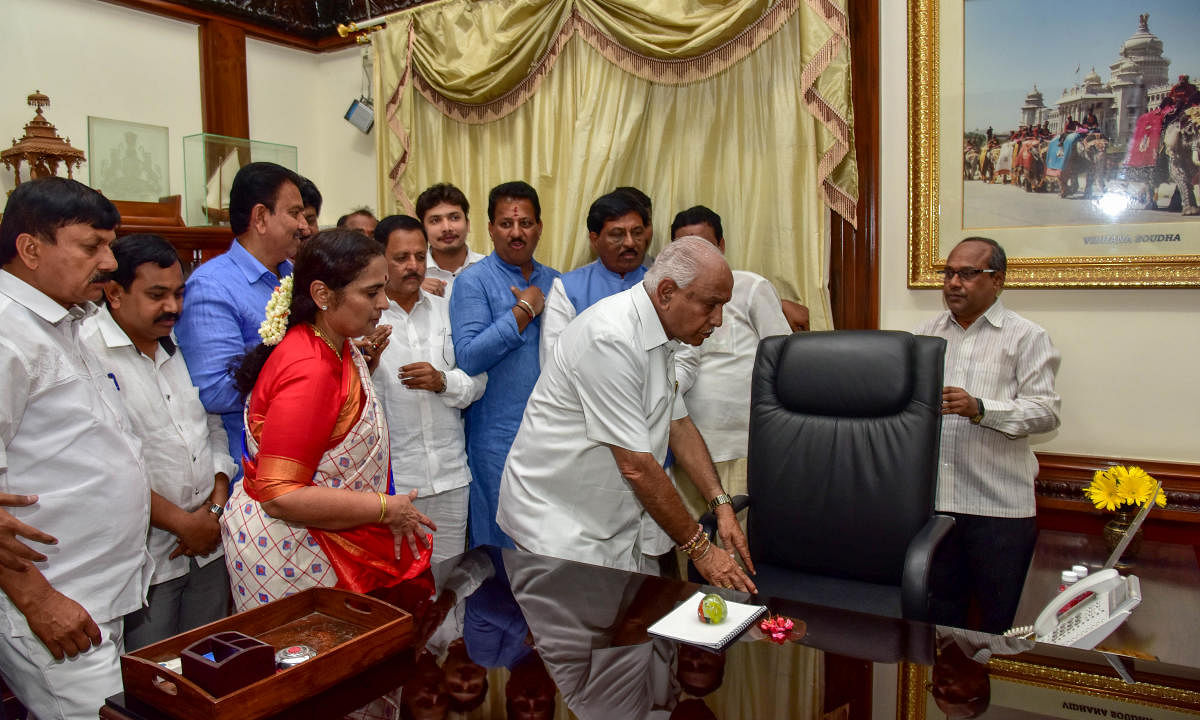Chief Minister B S Yeddyurappa offers puja to the chair before assuming office at the Vidhana Soudha on Thursday. DH Photo/ B H Shivakumar