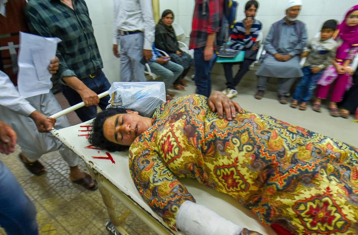 A woman injured in a grenade blast in Shopian is being shifted to a hospital in Srinagar on Monday. PTI