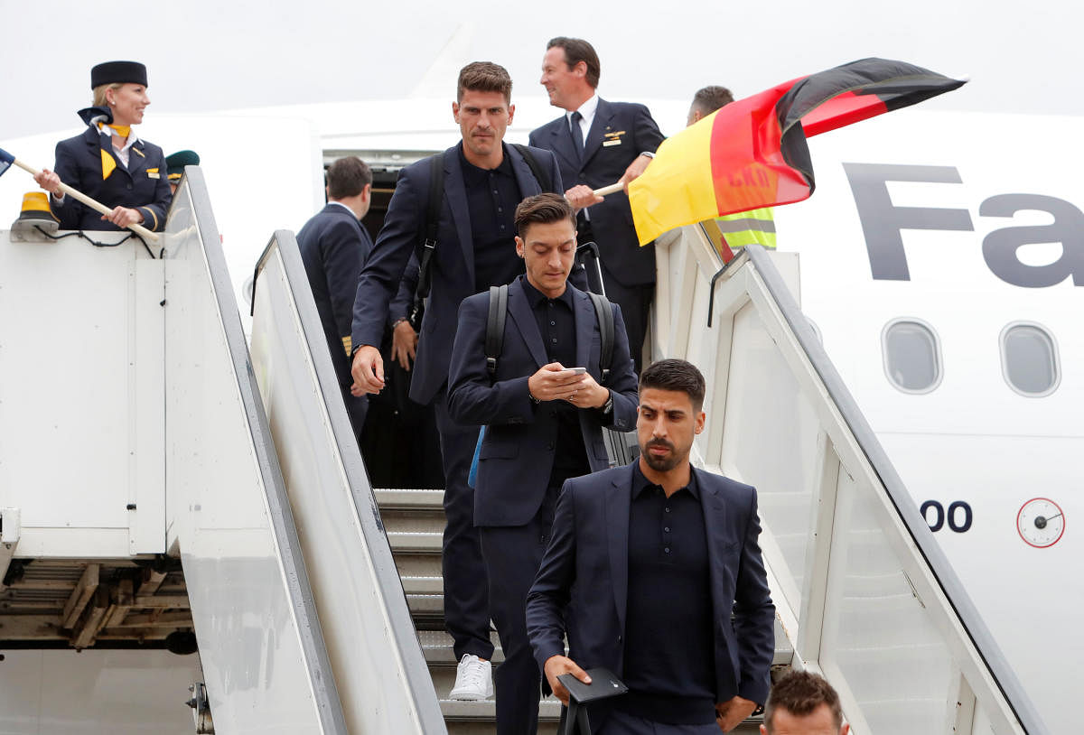 German players Sami Khedira (front) and Mesut Ozil (middle) touch down at the Vnukovo International Airport in Moscow on Tuesday. REUTERS 