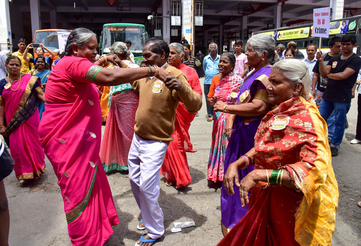 Senior citizens and members of the Nightingales Medical Trust break out into a dance during a roadshow at the Shivajinagar bus stand to mark World Elder Abuse Awareness Day on Friday. DH Photo/B H Shivakumar