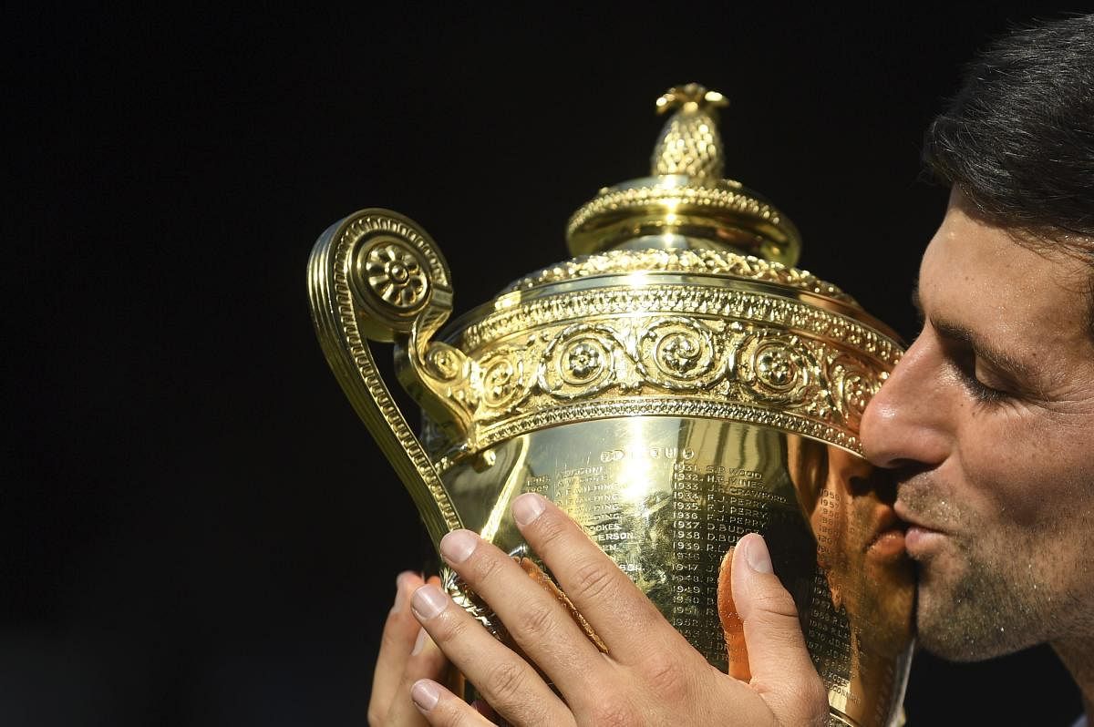 Novak Djokovic kisses the trophy after defeating Kevin Anderson of South Africa in the men's singles final match in London on Sunday.