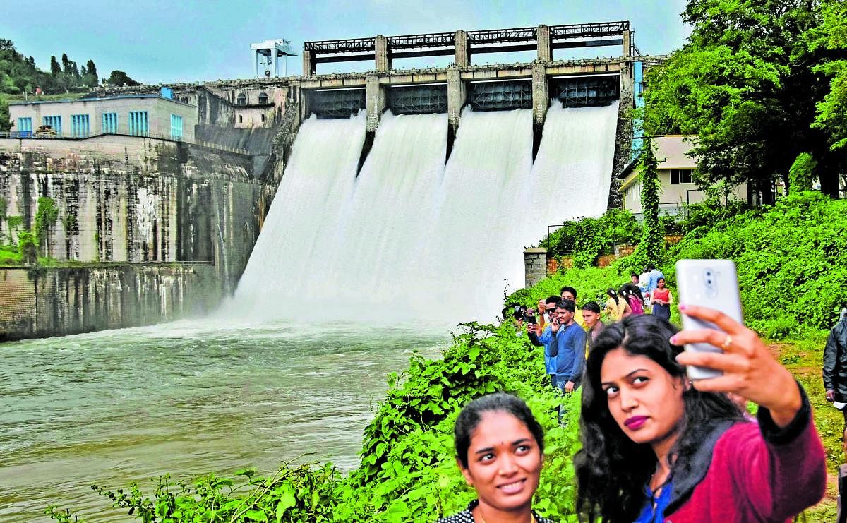 Girls take a selfie while water is released from Bhadra reservoir at Lakkavalli in Tarikere on Tuesday.