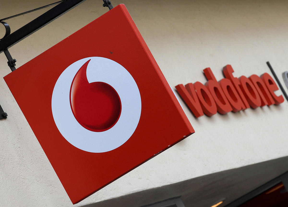 Branding hangs outside a Vodafone shop (Photo by Reuters)