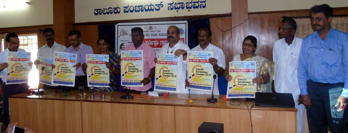 MLA Raghupathy Bhat and others release poster on Swachh Survekshan Grameen-2018 in Udupi on Saturday.