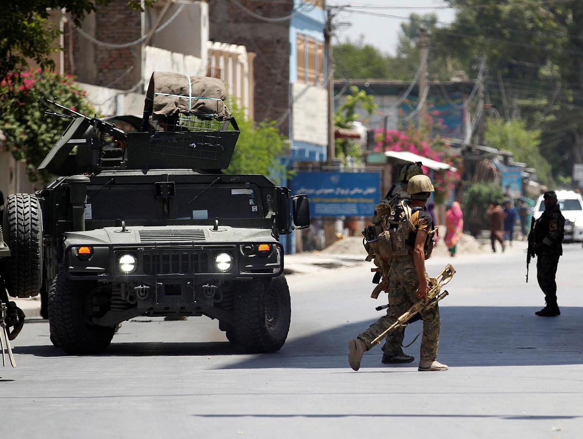 Afghan security forces arrive at an area where explosions and gunshots were heard, in Jalalabad city, Afghanistan, on Tuesday. (REUTERS)