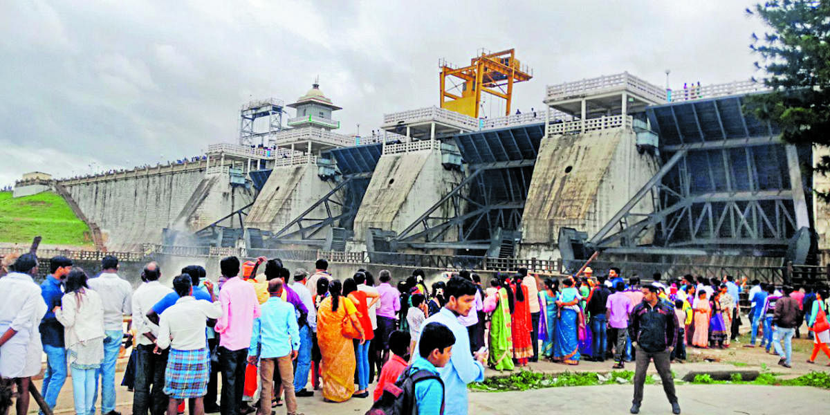 Tourists near the Kabini dam at Beechanahalli in HD Kote taluk as crest gates were opened on Saturday.