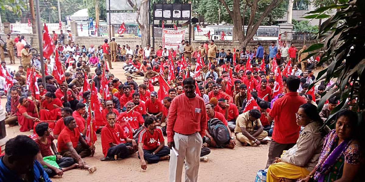 Members of the BWSSB union protest againt to demand menimum wages and job security infront of the labor commissioner office in Bengaluru on Monday.