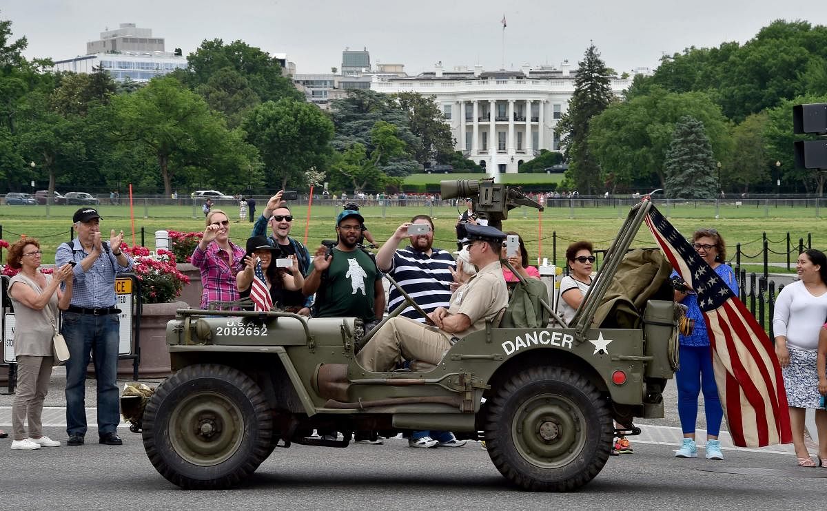In this file photo taken on May 30, 2016, participants ride a WWII Jeep in front of the White House during the Memorial Day Parade on Constitution Avenue in Washington, DC. AFP