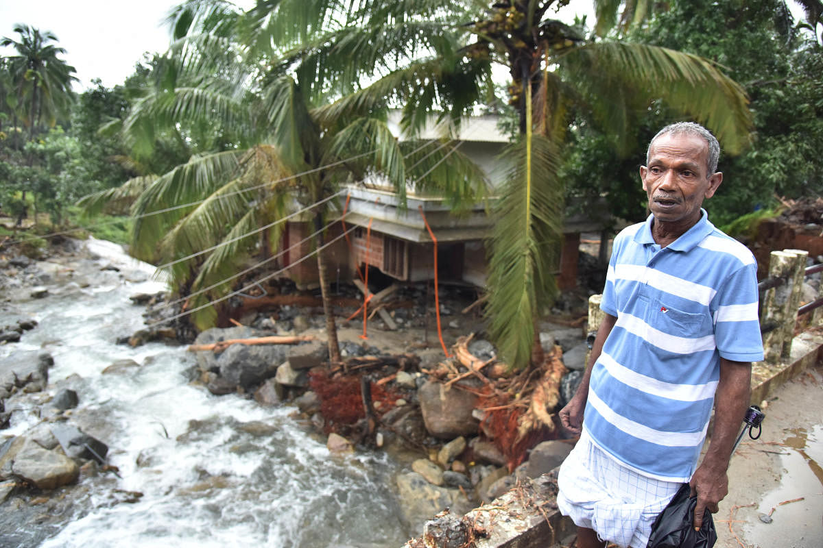 Subair near his son’s damaged house at Mattikunnu, Kozhikode, on Wednesday.  DH photo/ Janardhan B K