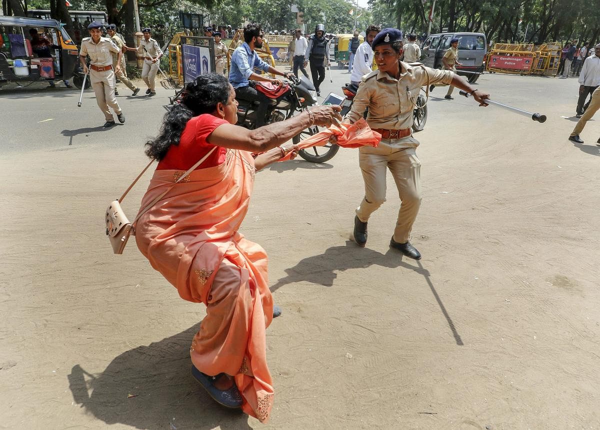 Police detain Congress party leaders and supporters during 'Khedut Aakrosh rally' and 'Assembly gherao march', in Gandhinagar, on Tuesday. PTI