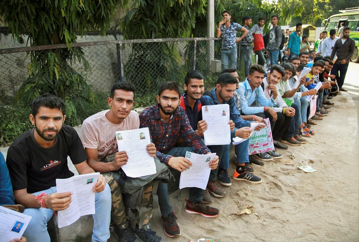 Special Police Officers (SPO) applicants wait at Police line to submit their forms, in Jammu. PTI