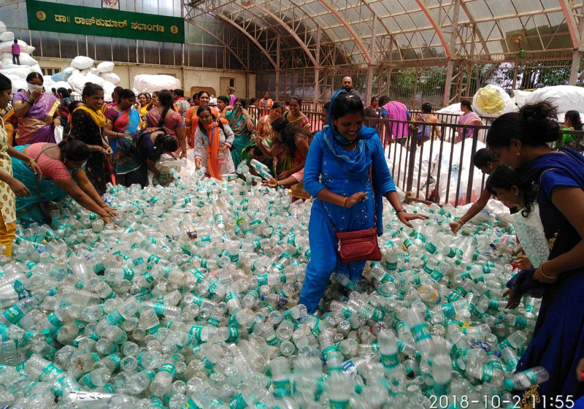 BBMP workers counting plastic bottles collected during the Plog Run, at BBMP head office on Tuesday. DH photo
