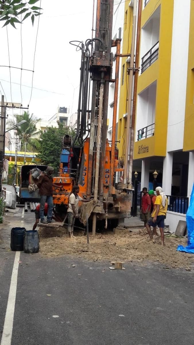 Wasted efforts: BBMP workers digging a borewell in the middle of the road at Vinayak Nagar on Thursday.