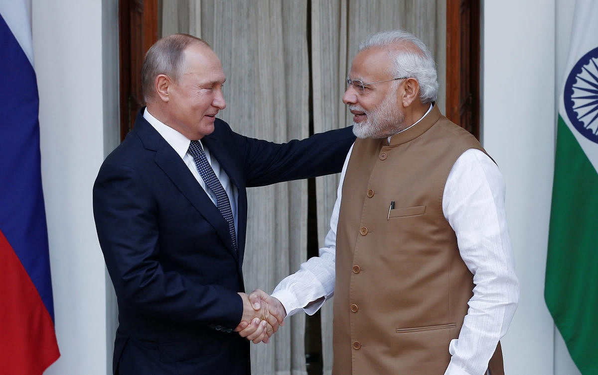 Russian President Vladimir Putin shakes hands with Prime Minister Narendra Modi ahead of their meeting at Hyderabad House in New Delhi, on October 5, 2018. REUTERS