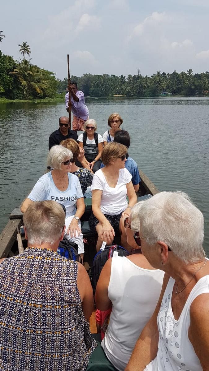 A group of Norwegian tourists on a backwater trip in Kerala