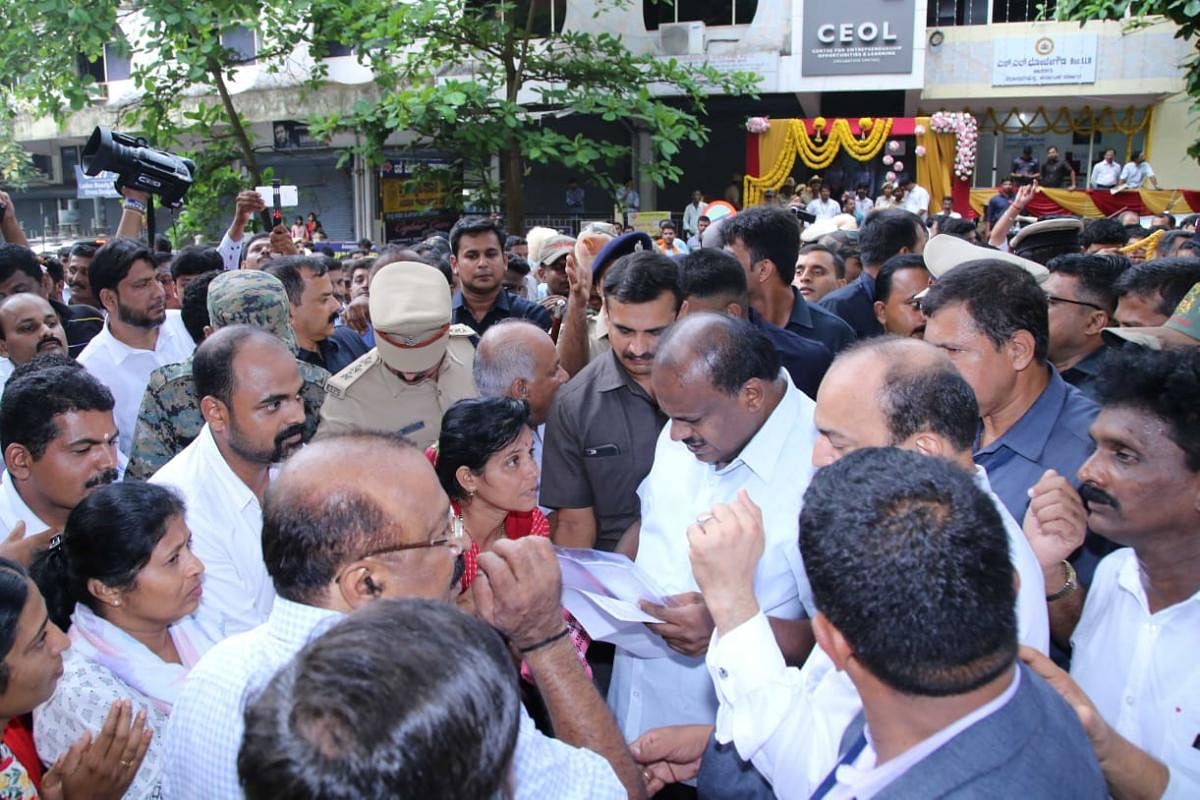 Chief Minister H D Kumaraswamy receives complaints from the people in Mangaluru on Sunday.