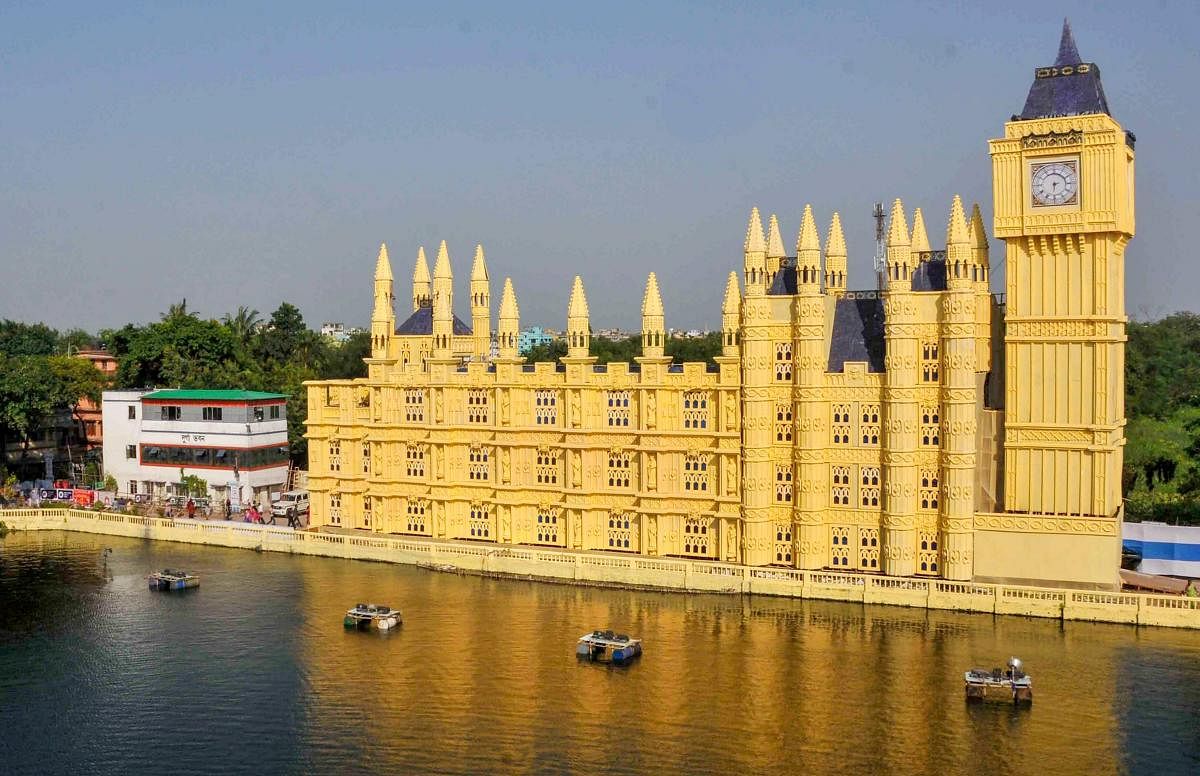A view of Durga puja pandal made as a replica of 'Palace of Westminster with Big Ben' during Durga Puja festival, in Kolkata, Tuesday, Oct 16, 2018. (PTI Photo)