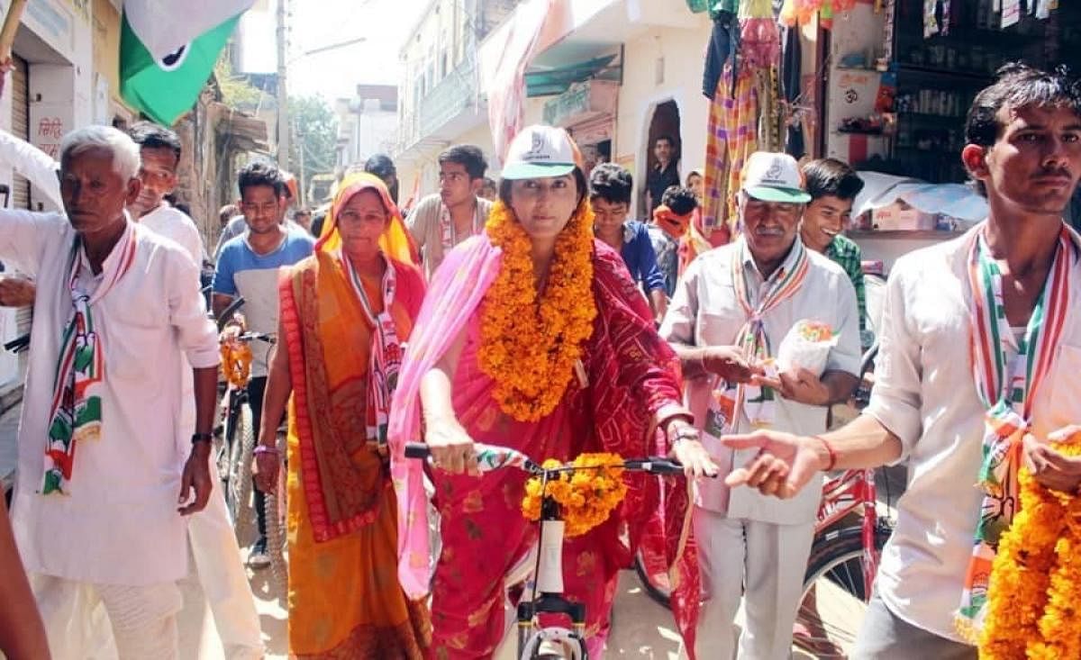 Rukshmani Kumari, an ex-royal and Rajasthan AIPC president takes cycle ride to reach villages in the Chomu constituency.