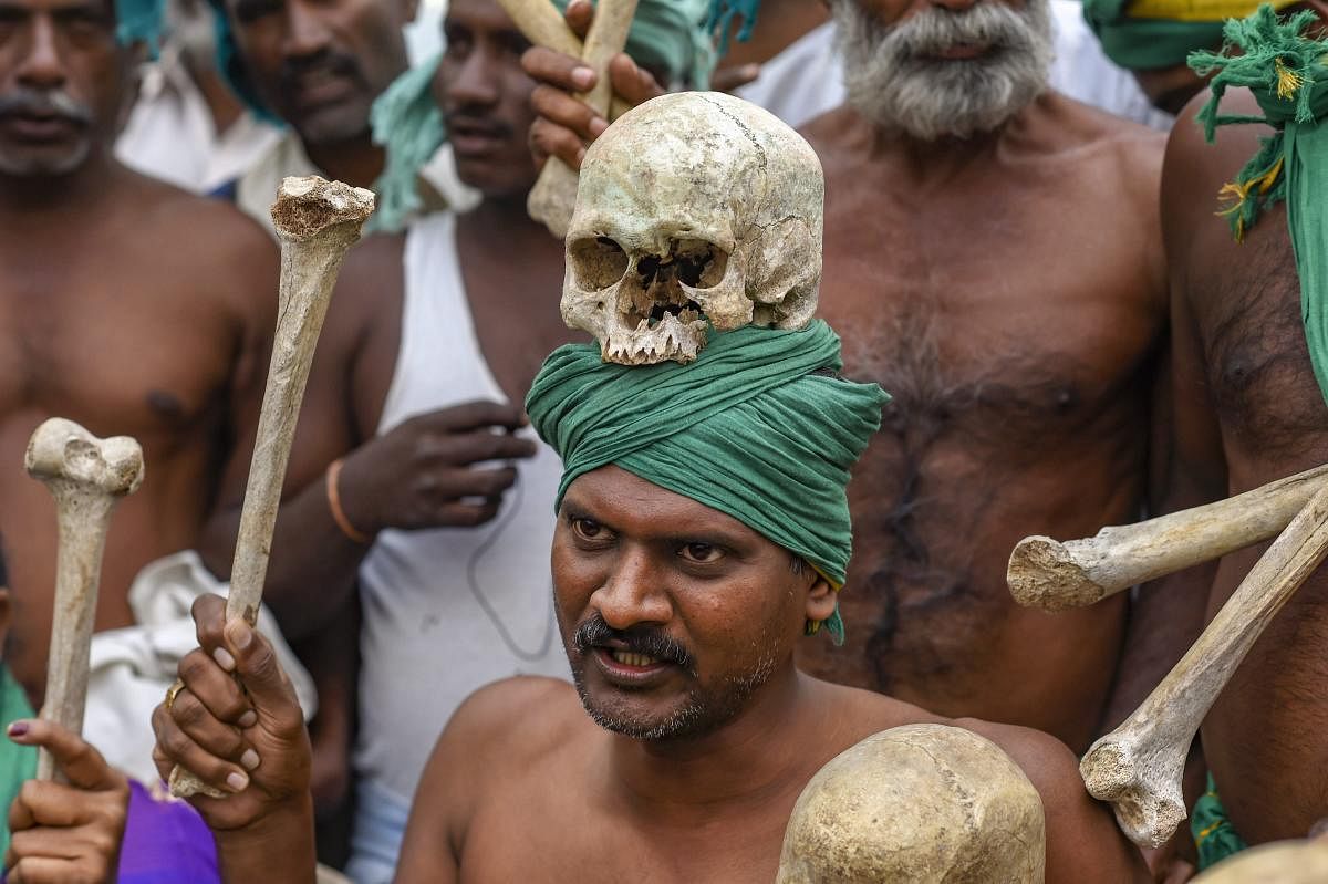 A farmer from Tamil Nadu display human skulls and bones during a protest ahead of their march towards Parliament, at Ramlila Maidan in New Delhi on Nov. 30, 2018. (PTI File Photo)