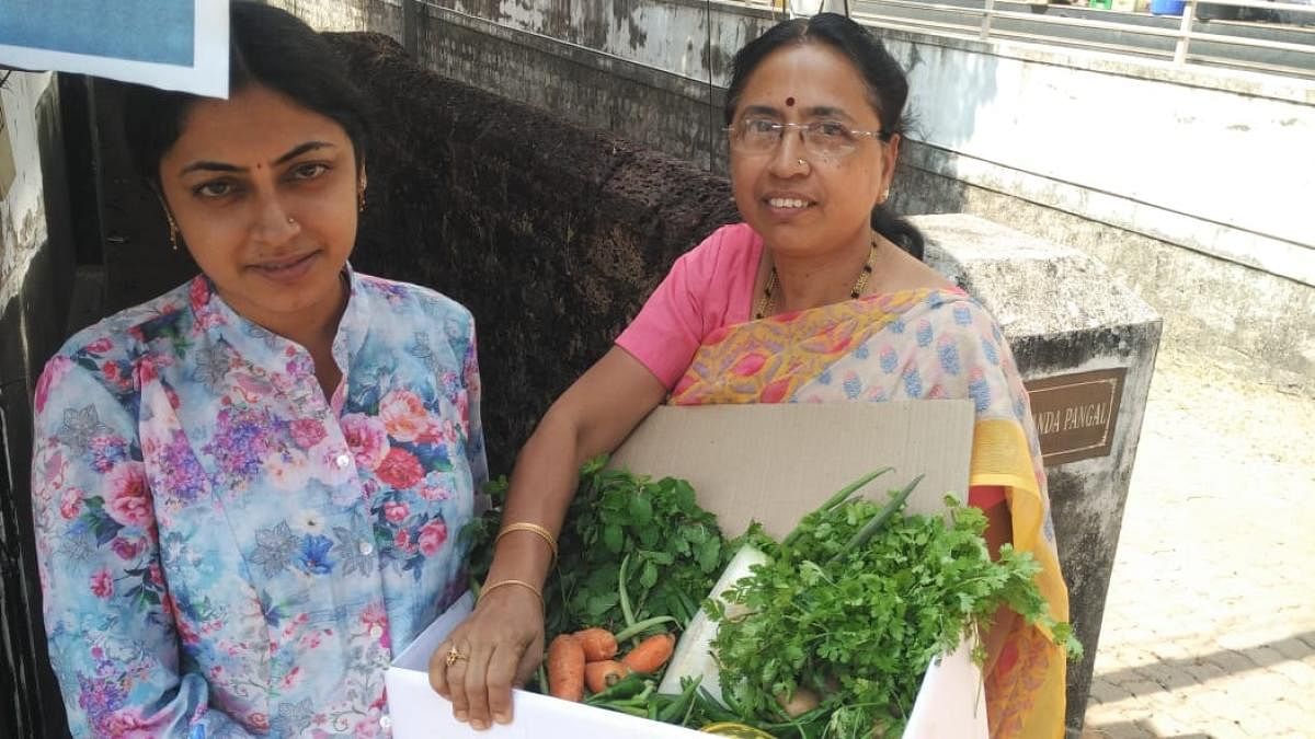 A customer seen with the organic vegetables delivered by the ECO – Friends Group in Mangaluru.