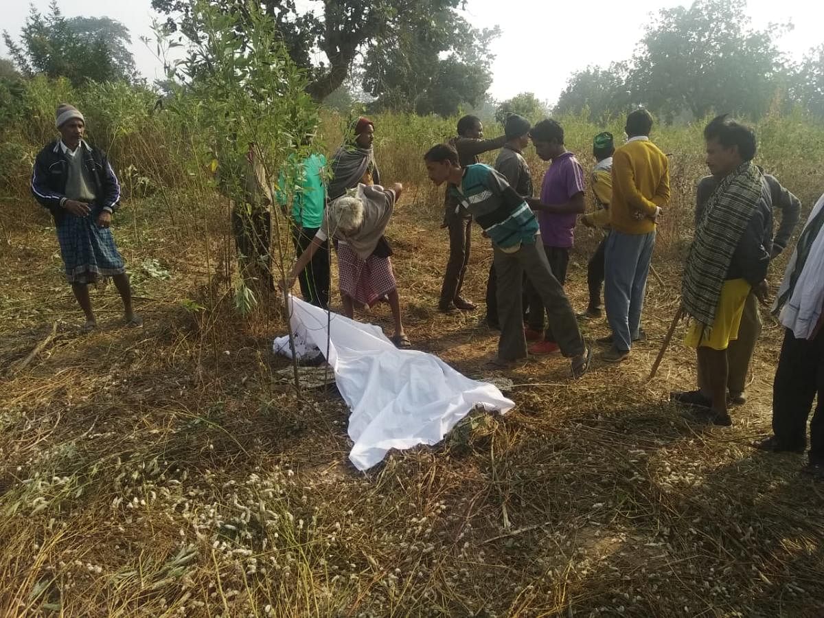 Villagers surround dead farmer Dev Kumar.