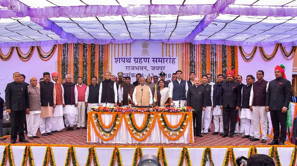 Rajasthan Governor Kalyan Singh, Chief Minister Ashok Gehlot, Deputy Chief Minister Sachin Pilot pose for a photograph with the newly sworn-in cabinet ministers during a ceremony at Raj Bhawan, in Jaipur. PTI file photo.