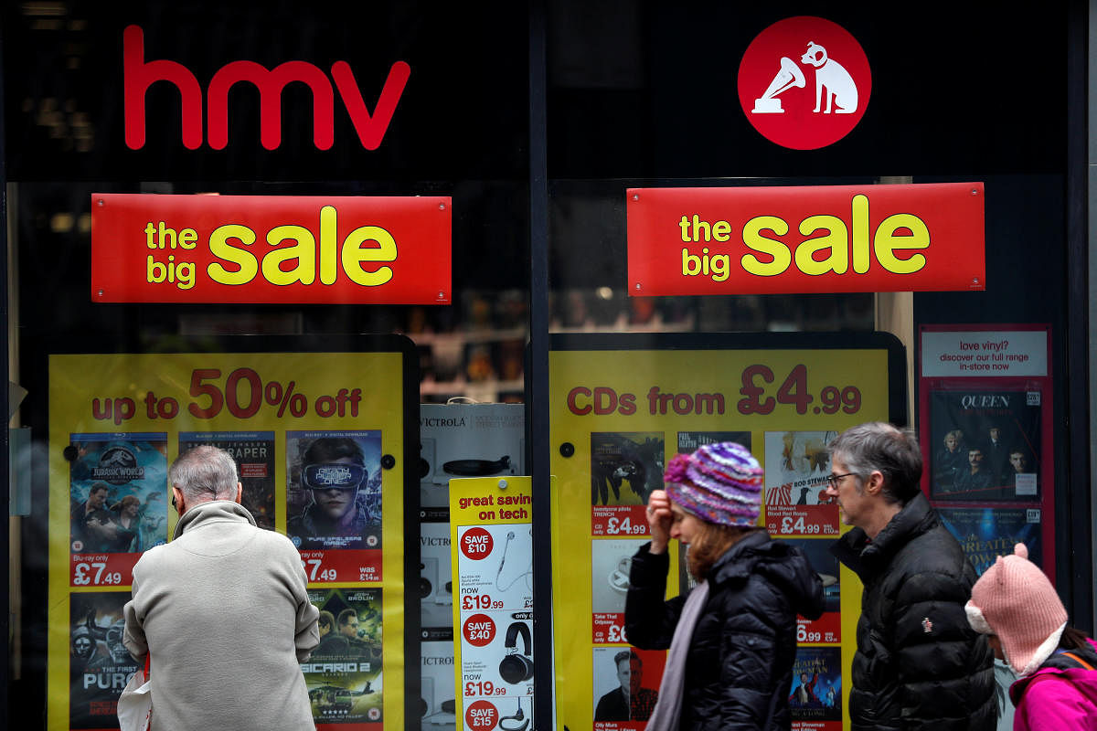 Pedestrians walk past an HMV shop in central London. (Reuters Photo)