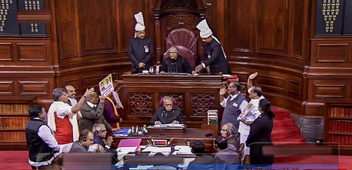 New Delhi: Members protest in the well of the Rajya Sabha in New Delhi, Monday. RSTV grab/ PTI Photo