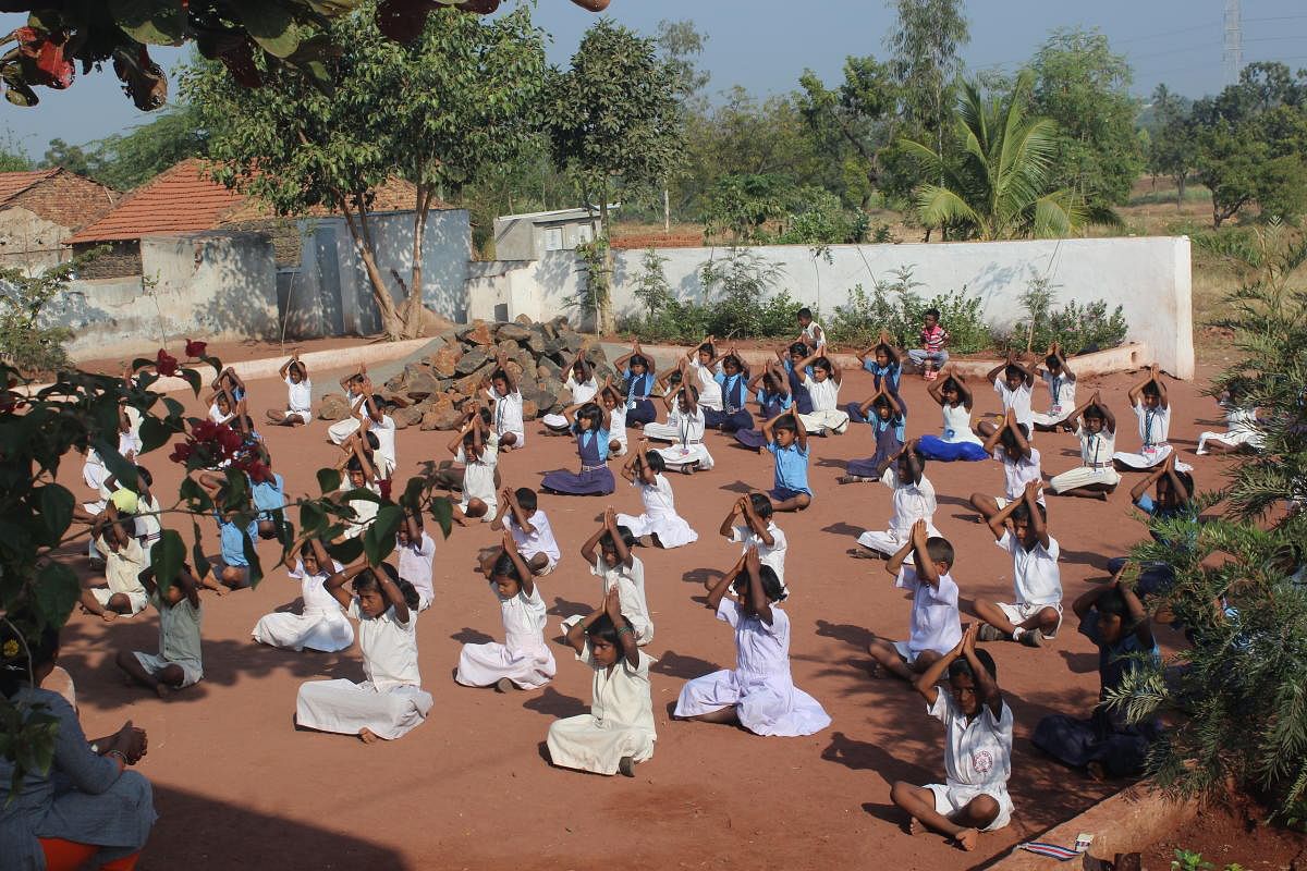Alive and kicking: Mass drill by school students in the renovated school premises; well-furnished classrooms; front exterior view of the school.