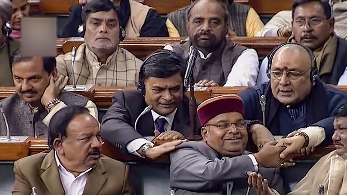 Social Justice Minister Thawarchand Gehlot and other MPS after Lok Sabha passes the bill to provide 10 per cent reservation in jobs and educational institutions to economically backward section in the general category, in Lok Sabha in New Delhi, Tuesday,