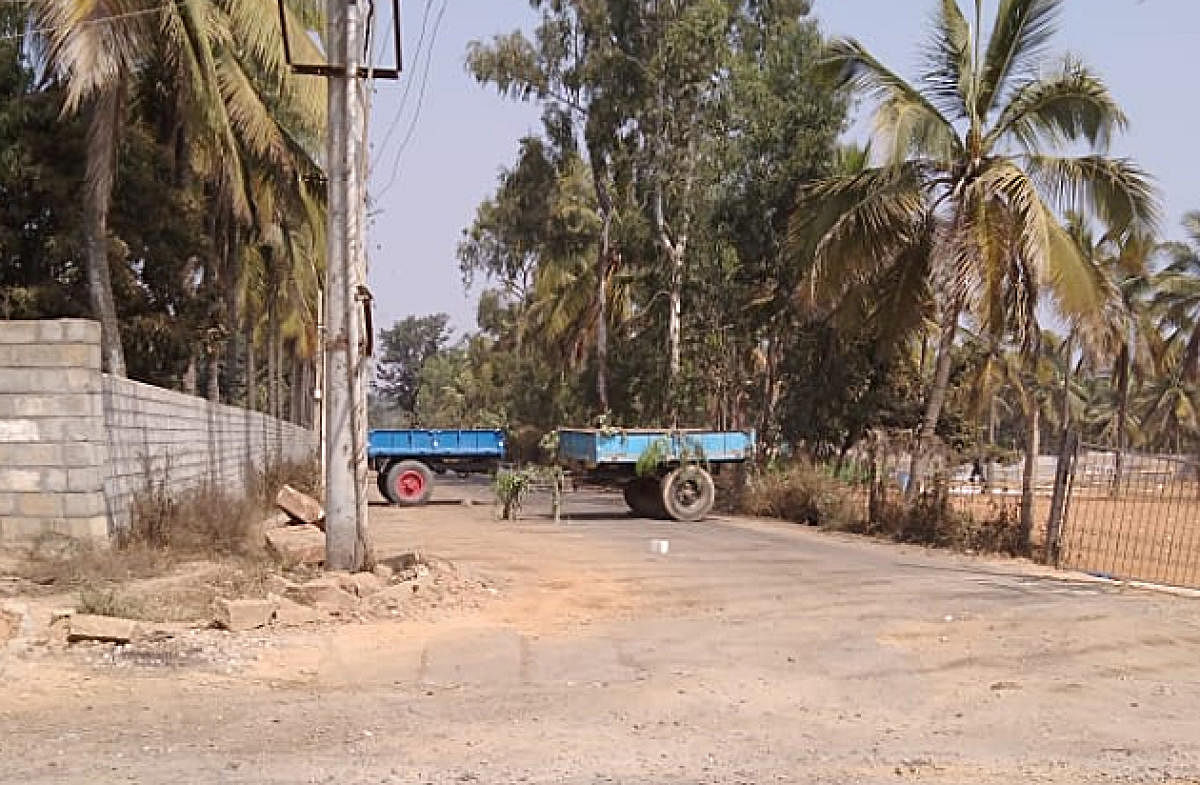 Villagers park tractors on the road to prevent garbage trucks from entering the quarry at Bellahalli in Bengaluru.