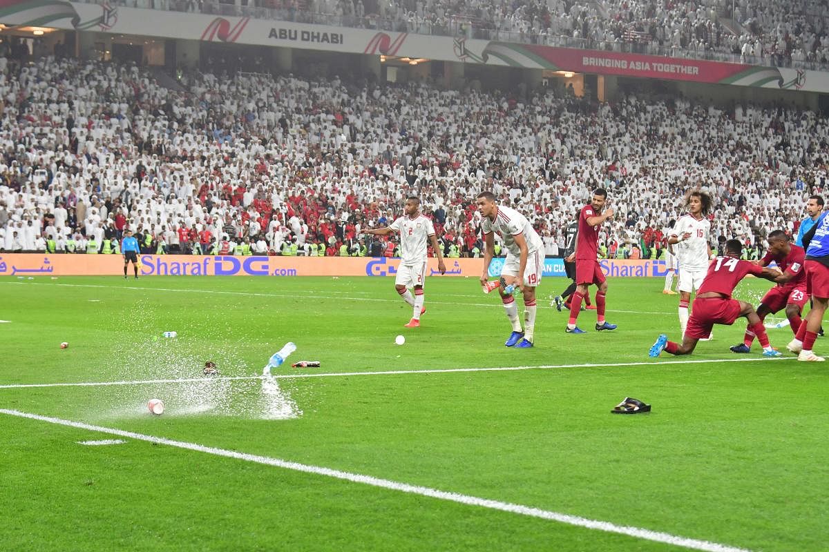Sandals and bottles are thrown at Qatar players as they celebrate a goal against UAE in the semifinal of the AFC Asian Cup in Abu Dhabi on Tuesday. Qatar defeated UAE 4-0 to set up a final clash against Japan. REUTERS