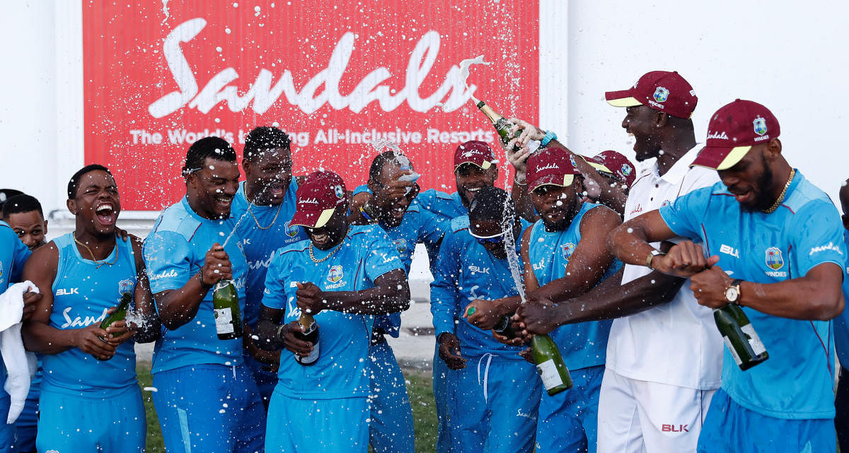 OVER THE MOON West Indies' players celebrate after the winning the series against England in Antigua on Saturday. REUTERS 