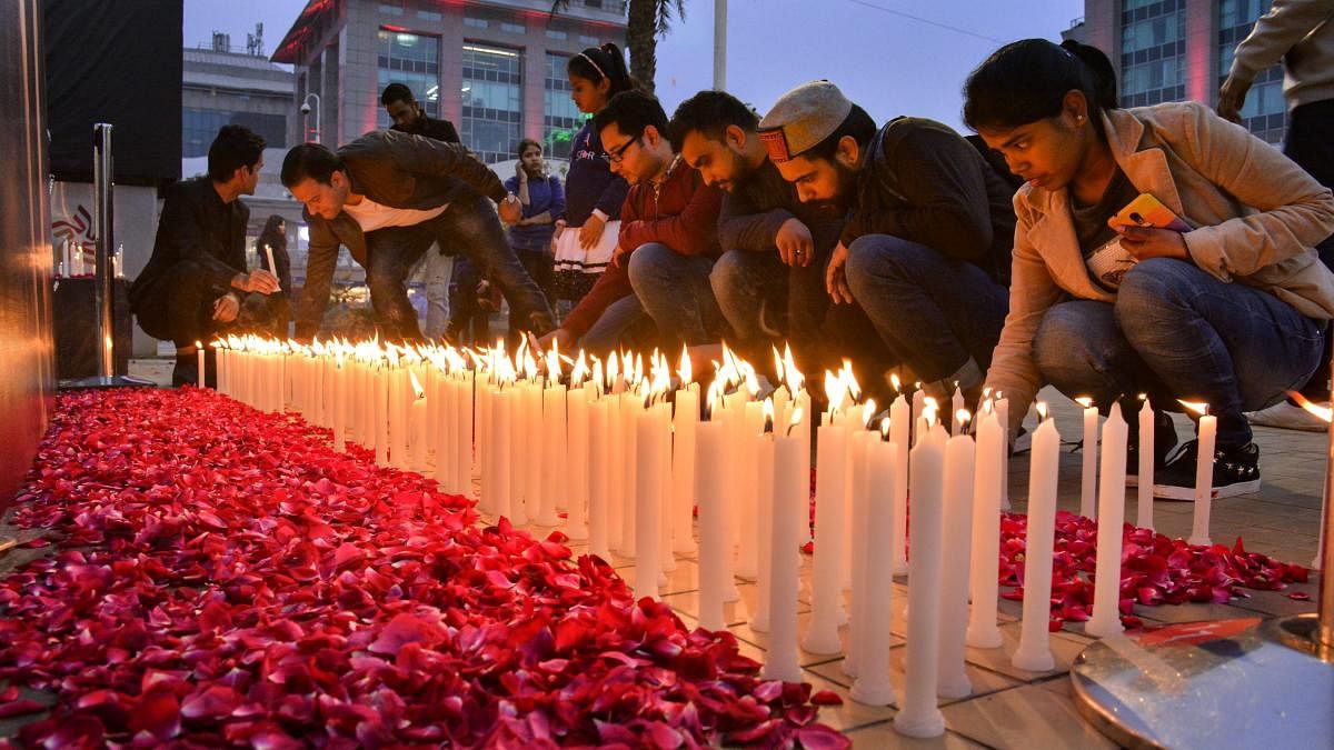 People light candles pay tribute to martyred CRPF jawans, who lost their lives in Pulwama terror attack, in New Delhi. (PTI Photo)