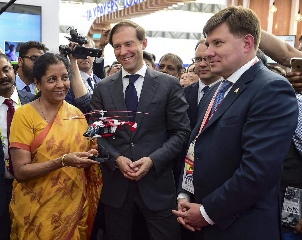 In one of the first business, deals struck at Aero India 2019, the Russian Helicopters Holding Company (a part of State Corporation Rostec) and a number of Indian companies signed Memorandums of Understanding.  In photo: Union Defence Minister Nirmala Seetharaman receives a miniature helicopter as a memento from Russian stall after inauguration of the 12th edition of 'AERO India 2019' at Yelahanka Air Base, in Bengaluru, Wednesday, Feb 20, 2019. PTI photo. 