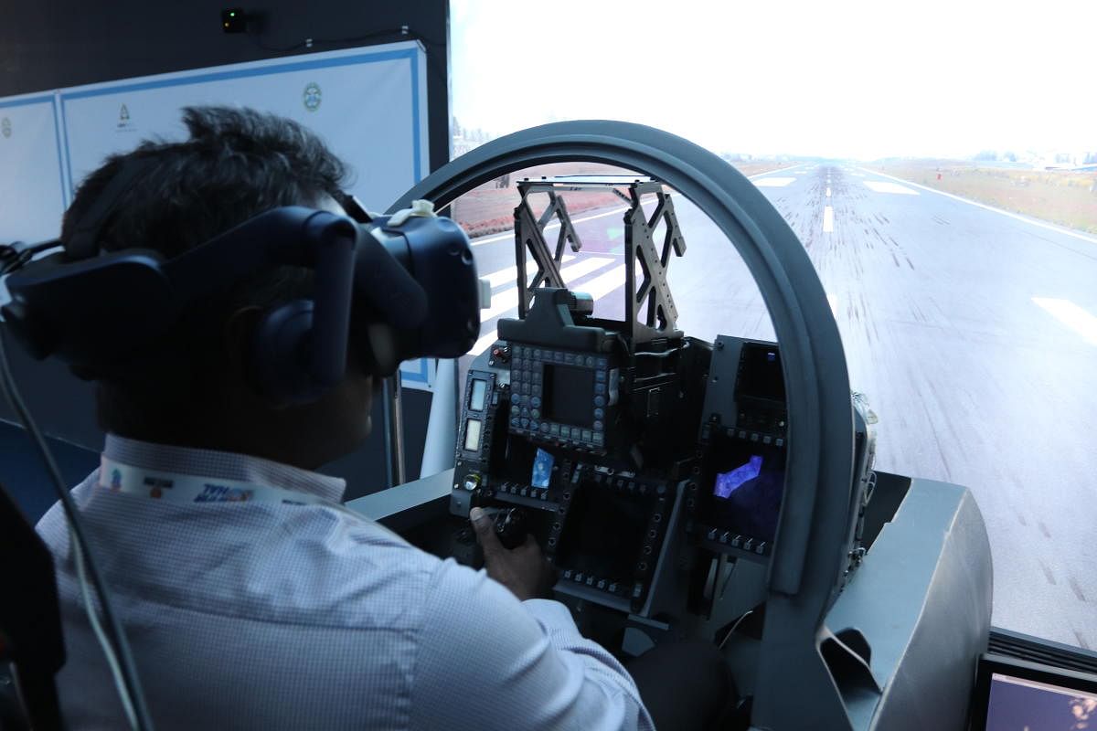 ADA Senior Scientist Suresh Kumar P wears a virtual reality helmet while using the Tejas Cockpit Design Mockup during Aero India 2019. DH PHOTO