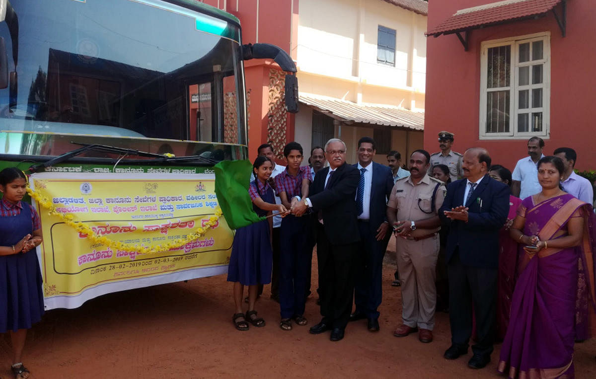 Principal District and Sessions Judge C M Joshi flags off the Legal Literacy Chariot on the premises of district court in Udupi on Thursday.