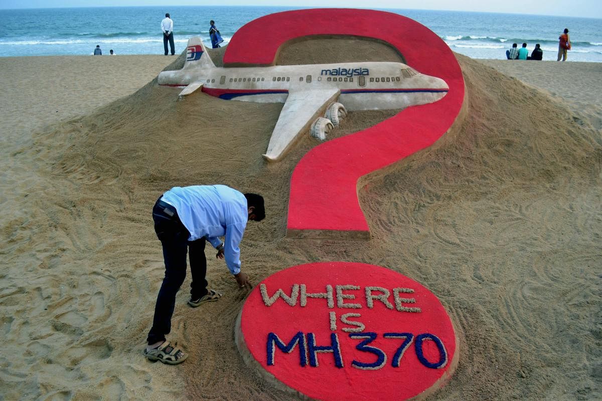 This file photo taken on March 7, 2015, shows Indian sand artist Sudarsan Pattnaik creating a sculpture of missing Malaysia Airlines flight MH370 on Puri beach in eastern Odisha state (AFP)