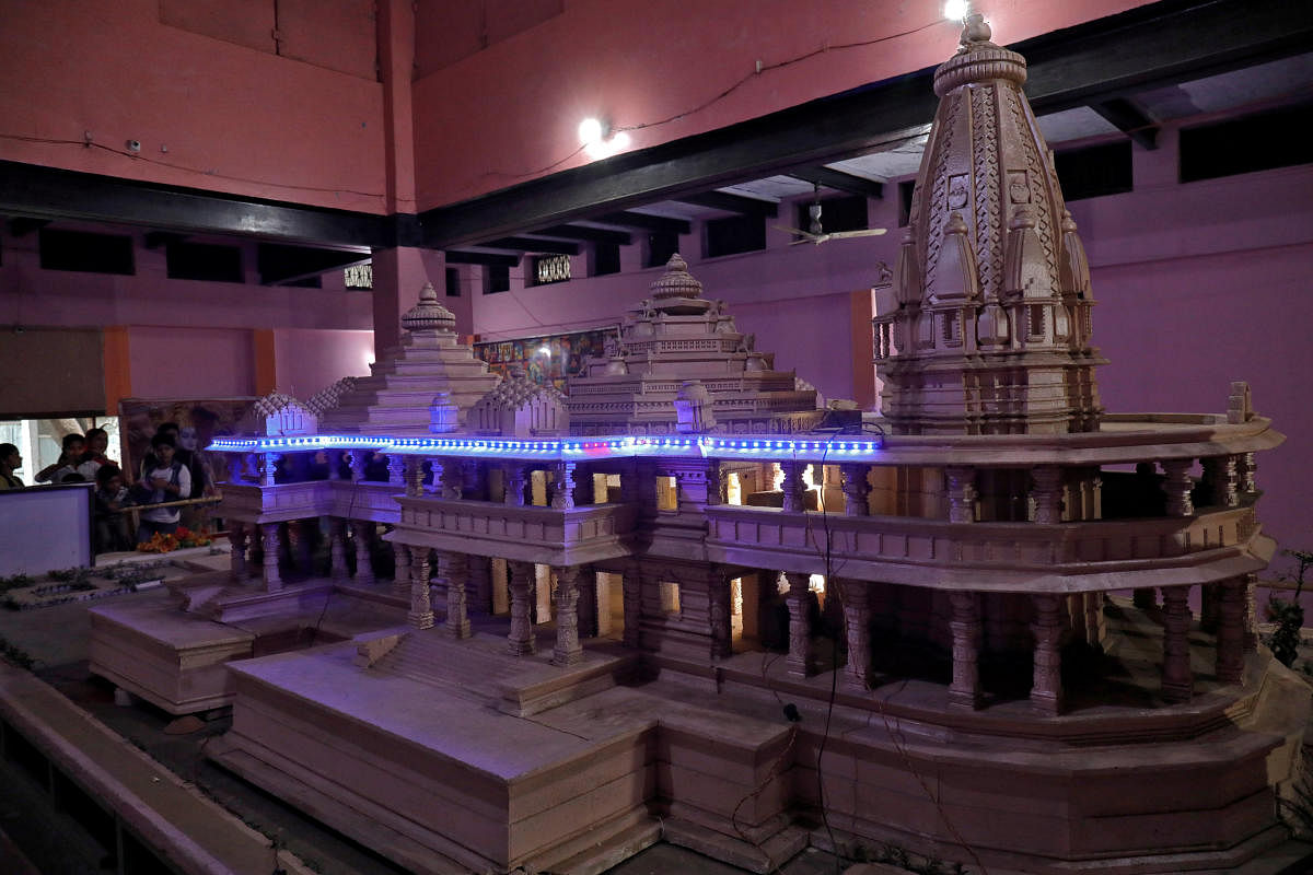 People look at a model of a proposed Ram temple that Hindu groups want to build at a disputed religious site in Ayodhya in Uttar Pradesh. REUTERS file photo