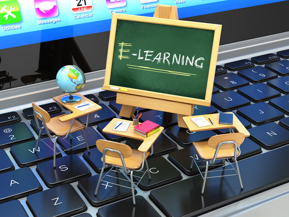 E-learning, online education concept. Blackboard and school desks on laptop keyboard. 3dEducation
