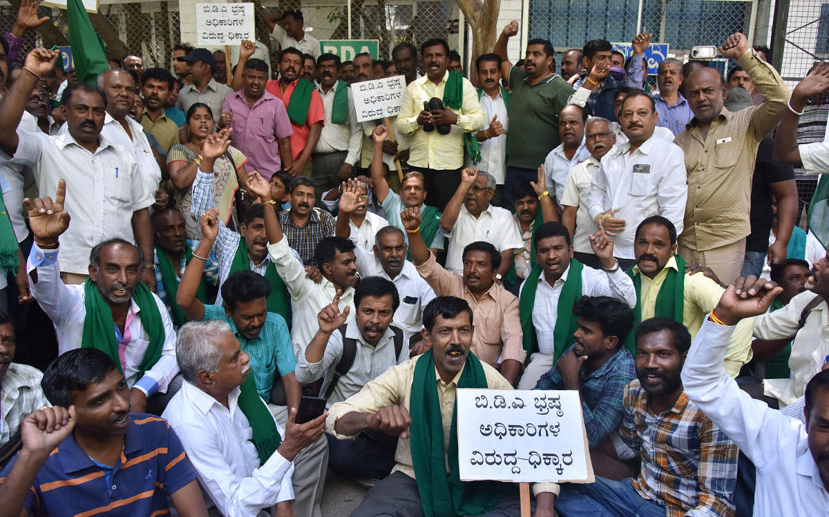 Farmers protested outside the BDA head office against the delay in the Peripheral Ring Road (PRR) project on Tuesday and then went for an overnight sit-in. DH PHOTOs/JANARDHAN B K and b h shivakumar