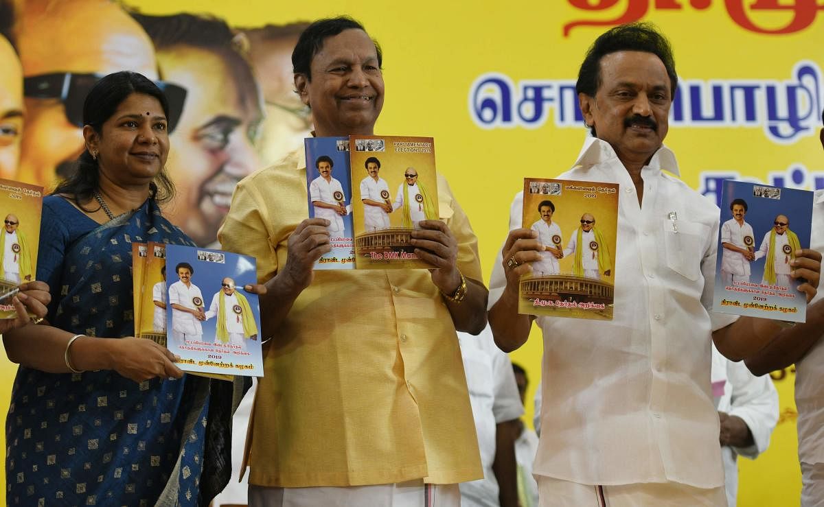 DMK party chief M K Stalin, DMK principal secretary T R Balu (C) and DMK women's wing secretary M Kanimozhi, hold the party's manifesto during its release for the forthcoming general election at the party's headquarters in Chennai on Tuesday. AFP