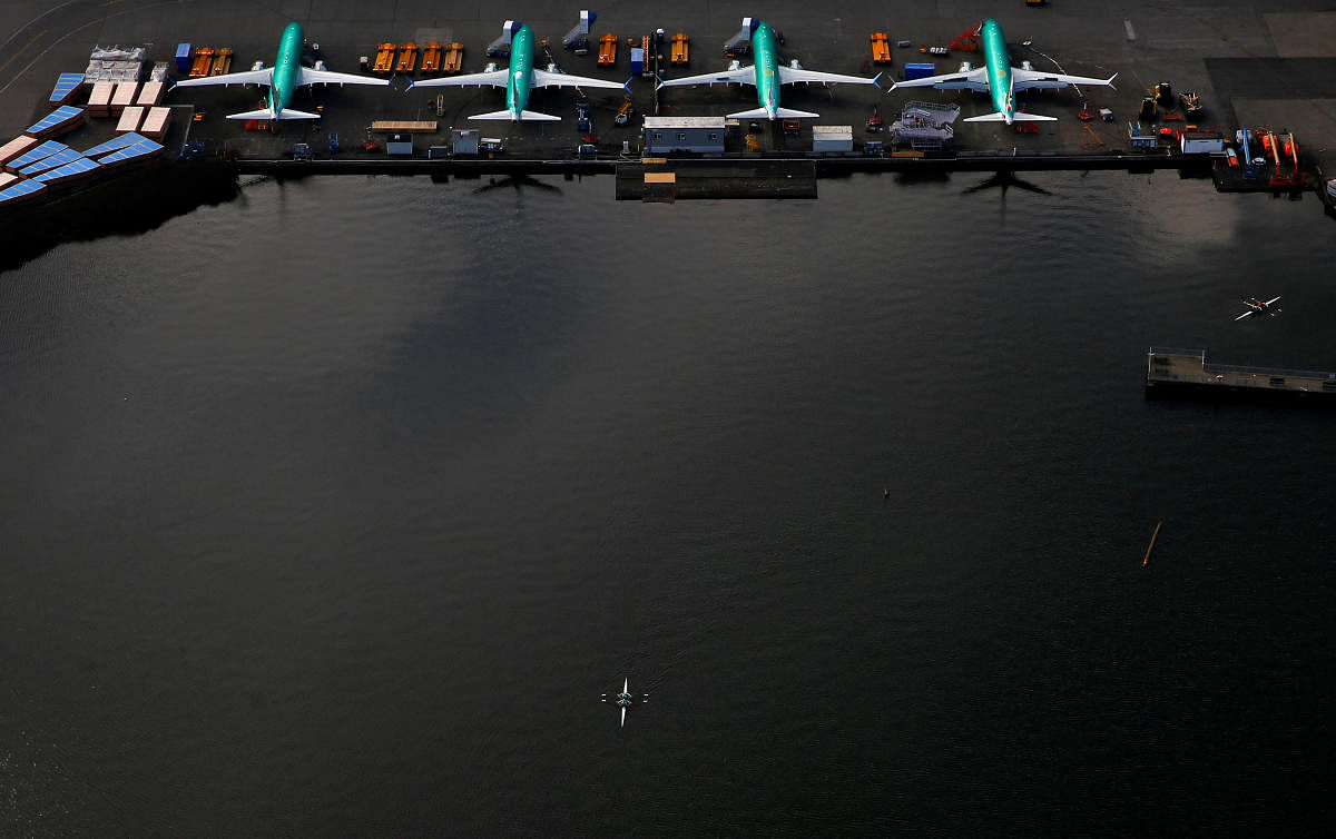 An aerial photo shows rowers on Lake Washington near a line of Boeing 737 MAX aircraft at the Boeing factory in Renton, Washington, U.S. March 21, 2019. Picture taken March 21, 2019. REUTERS/Lindsey Wasson