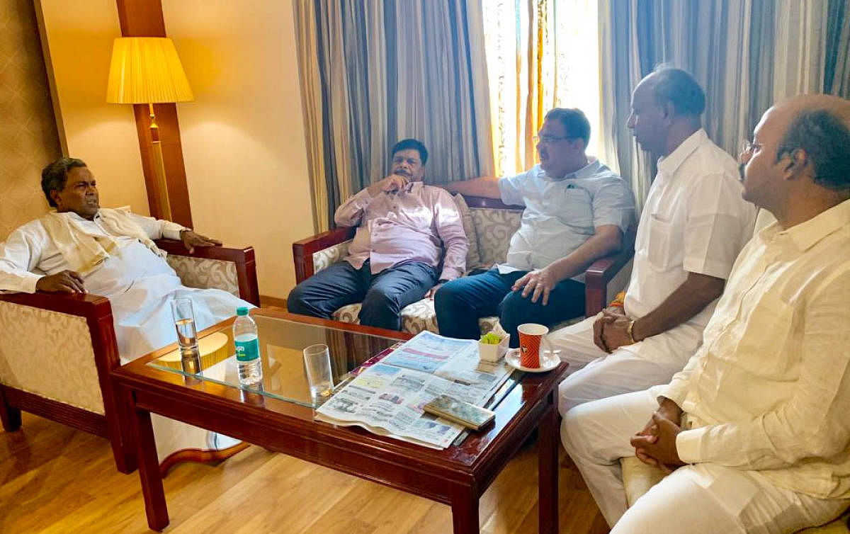 JD(S)-Congress coalition coordination committee chairman Siddaramaiah discusses with former minister Dr H C Mahadevappa, MLAs Tanveer Sait, Yatheendra Siddaramaiah and Congress candidate C H Vijayashankar, at a private hotel in Mysuru, on Sunday. pic by s