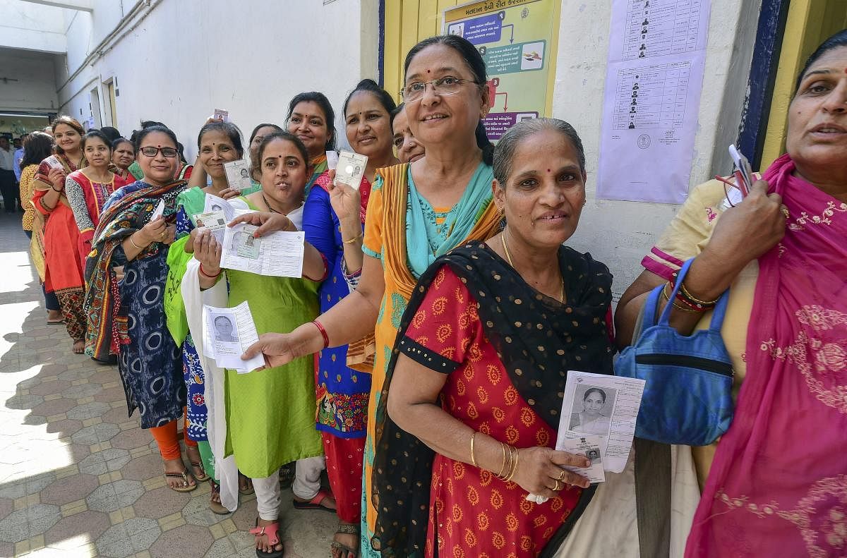 Ahmedabad: Women voters queue up to cast their votes at a polling station, during the third phase of the 2019 Lok Sabha polls, in Ahmedabad, Tuesday, April 23, 2019. (PTI Photo/Santosh Hirlekar) (PTI4_23_2019_000250B)