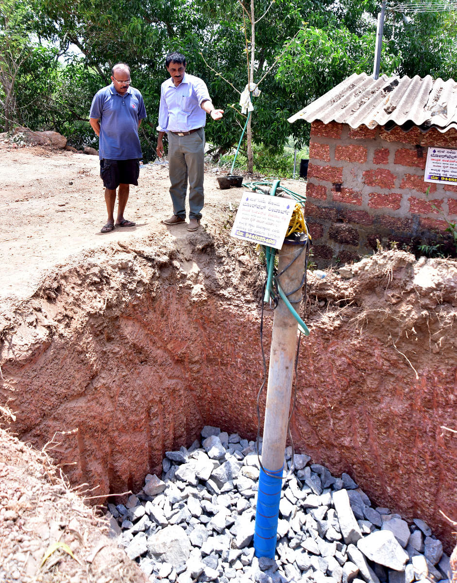 Hydrogeologist and rainwater harvesting consultant N J Devaraja Reddy explains borewell recharge method to research scientist Kiran Kumar Shetty at Pavoor, on the outskirts of Mangaluru.