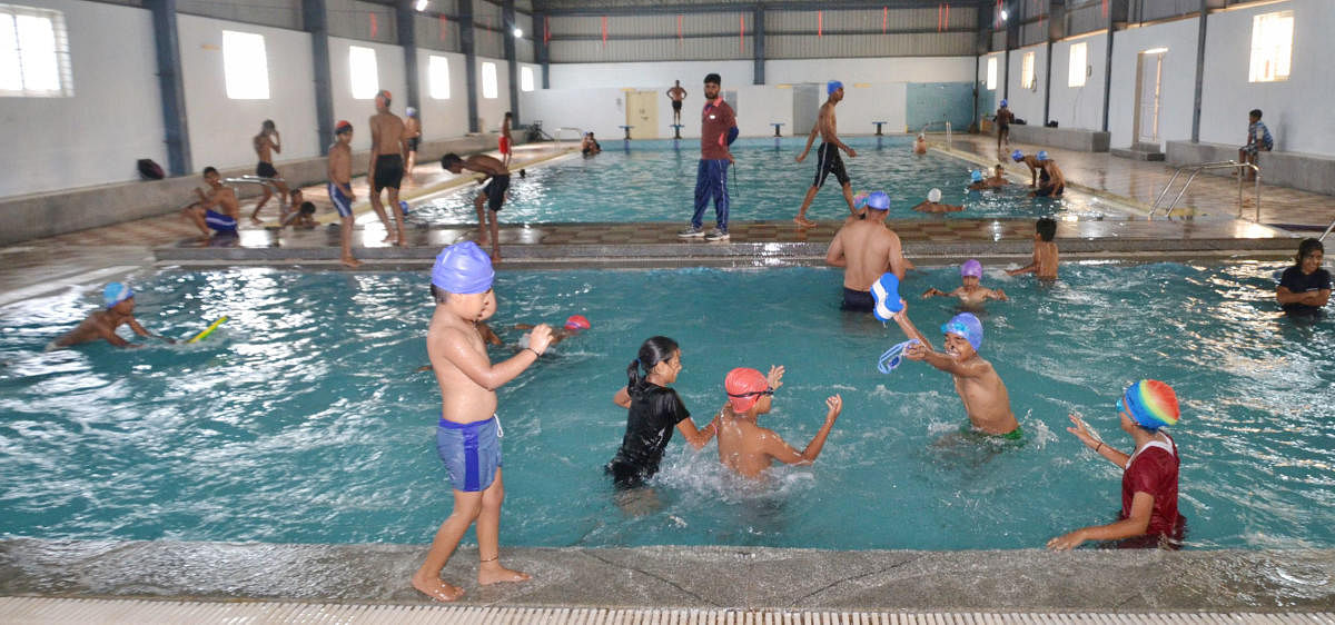 Children having fun at the swimming pool in General Thimayya Stadium in Madikeri.